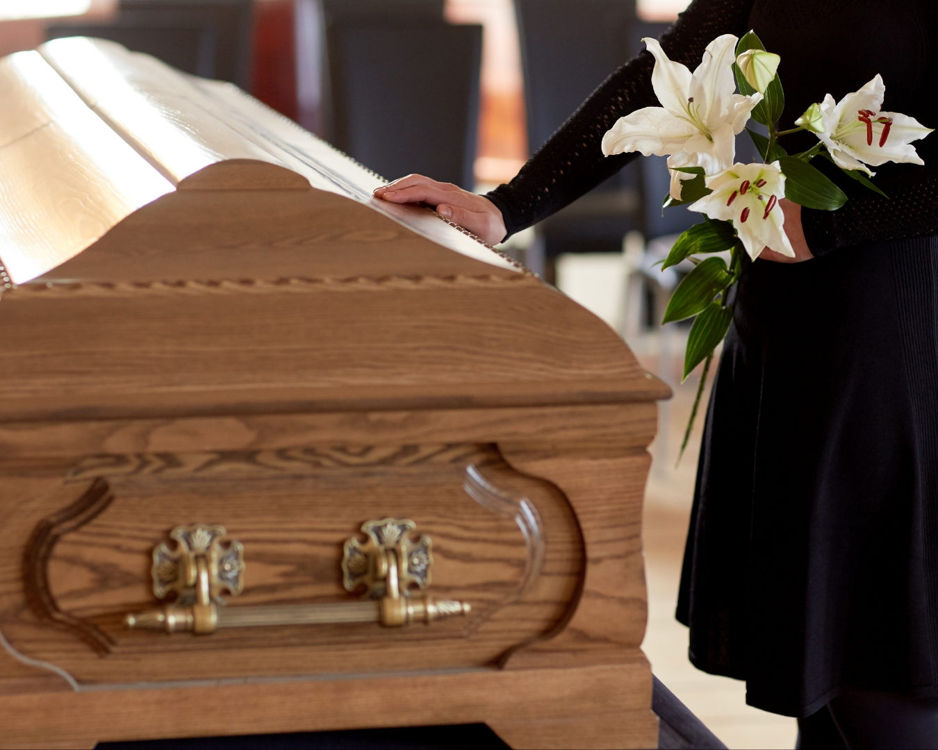 Funeral service scene with wooden casket and white lilies at South Carolina funeral home